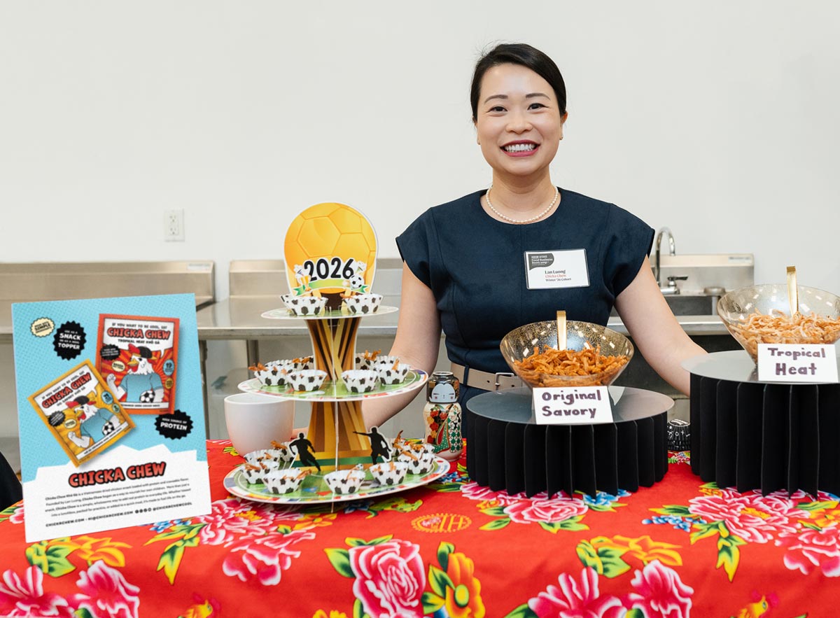 Founder Lan Luong standing behind a table with snacks and promotional materials